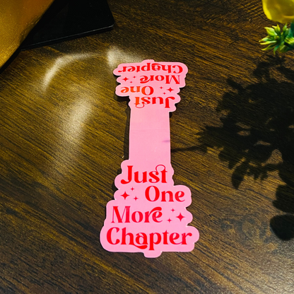 Pink bookmark with text on a wooden surface